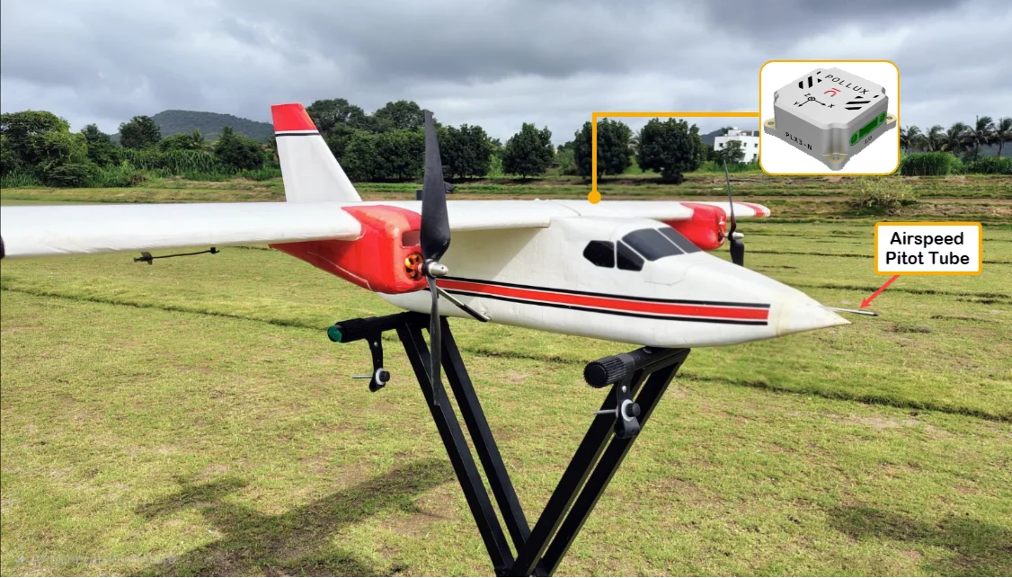 Fixed-wing test UAV on its stand, with callouts for the Pollux 3 INS and the airspeed pitot tube